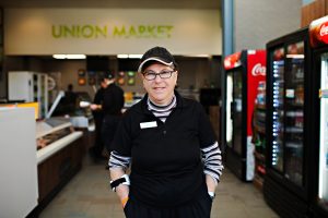 Person supported by KW Career Compass smiling in front of the Union Market.
