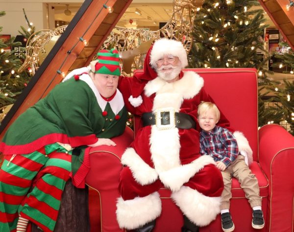 Jessica as an Elf pictured with Santa and a guest child at the Mall.