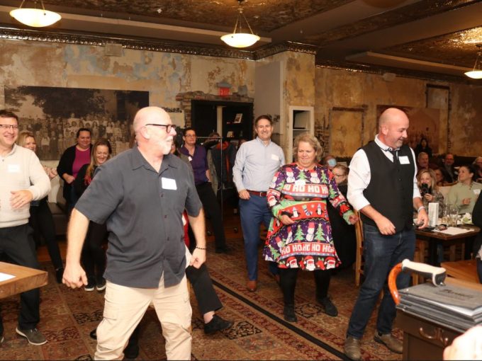 Staff dancing in a flash mob at restaurant during 2023 Staff Recognition event.