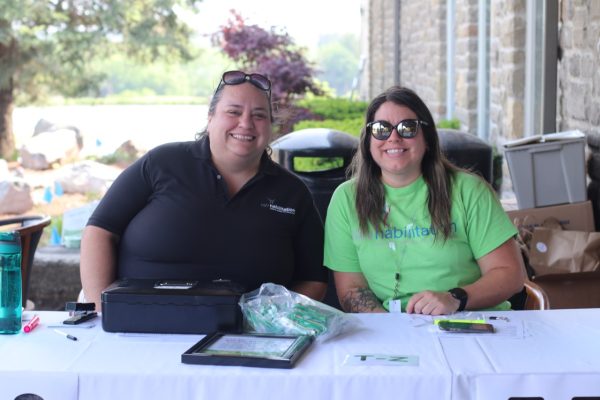 Staff smiling at the registration table at KW Habilitation's 2023 Annual Golf Tournament.