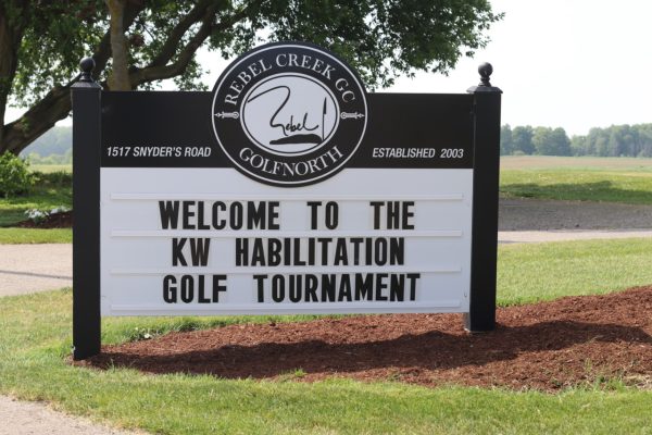 2023 Annual Golf Tournament sign that says: Rebel Creek Golf Club, Golf North, Welcome to the KW Habilitation Golf Tournament.