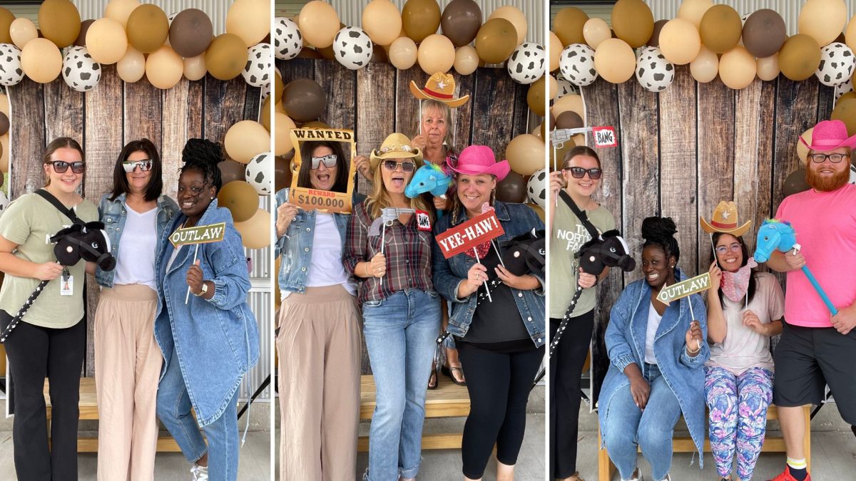 11 people from Early Learning enjoying our country western themed Staff Appreciation Day photo booth. They are all holding funny props like toy horses and cowboy hats.